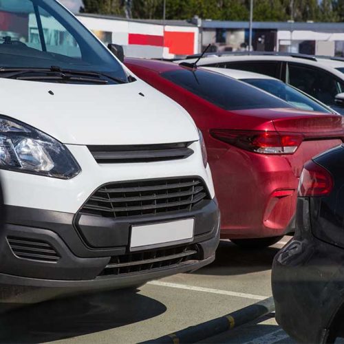 Cars in the Parking Lot in the City near the Shopping Mall